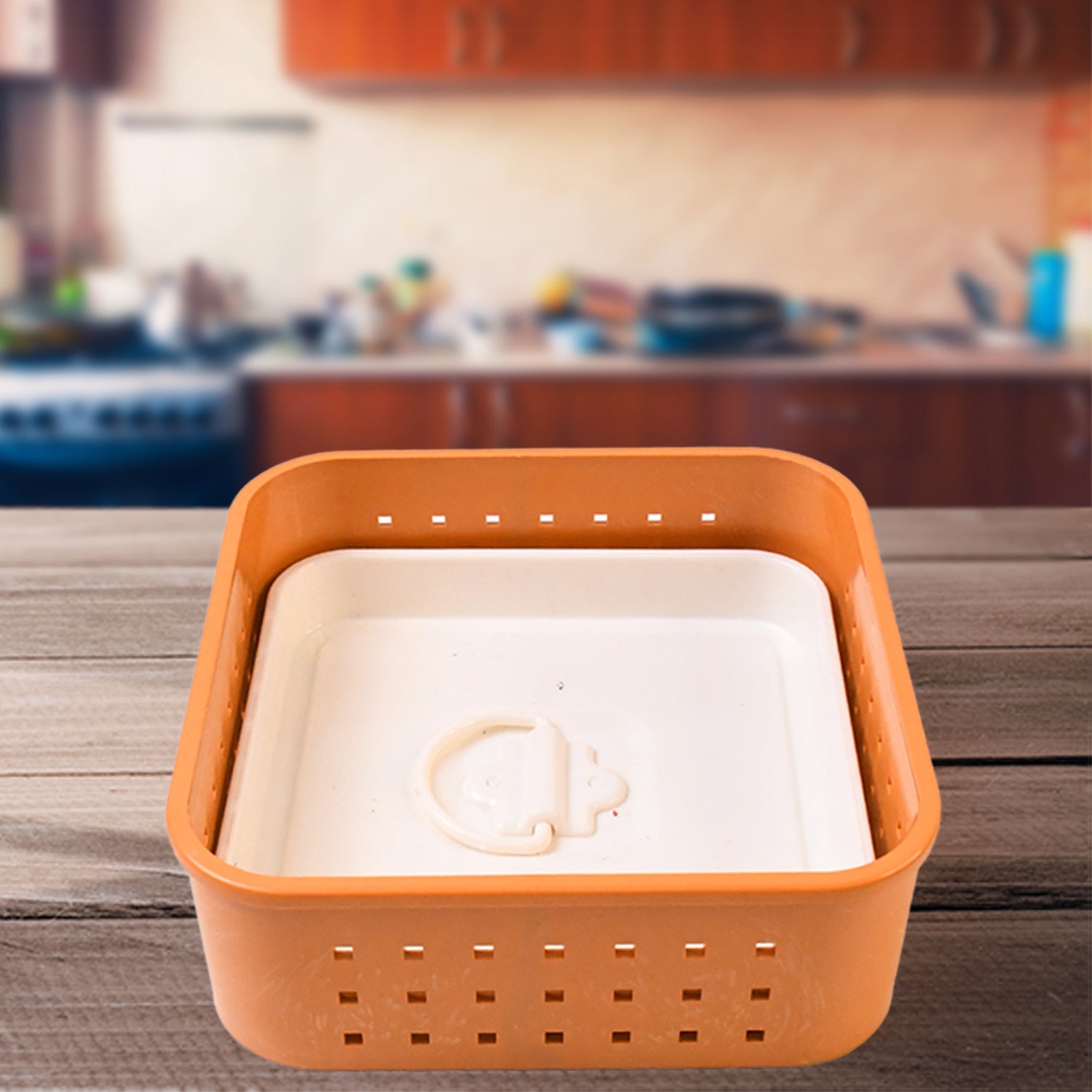 Orange plastic basket with white interior on a wooden surface in a kitchen setting