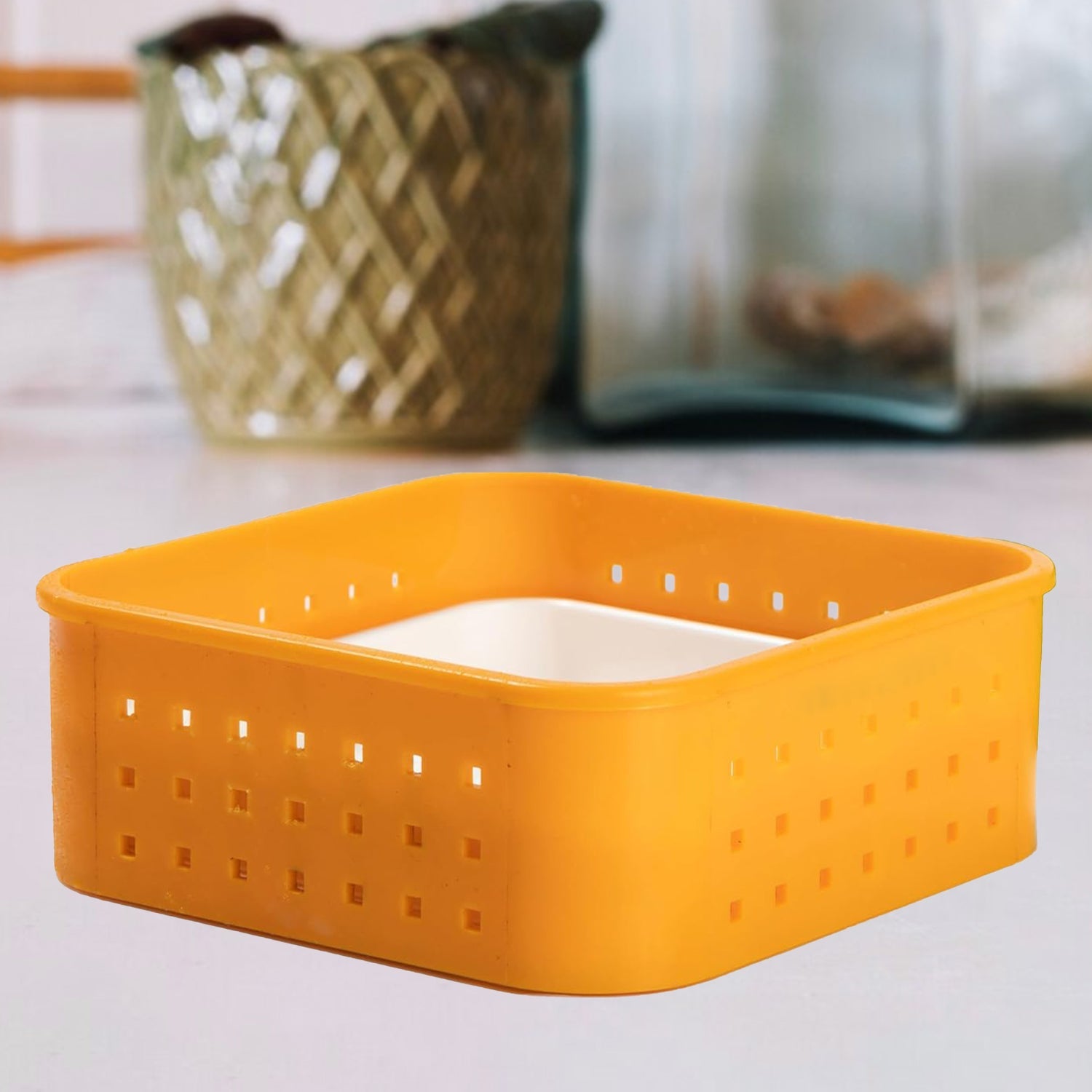 Yellow storage basket on a light surface with a blurred background