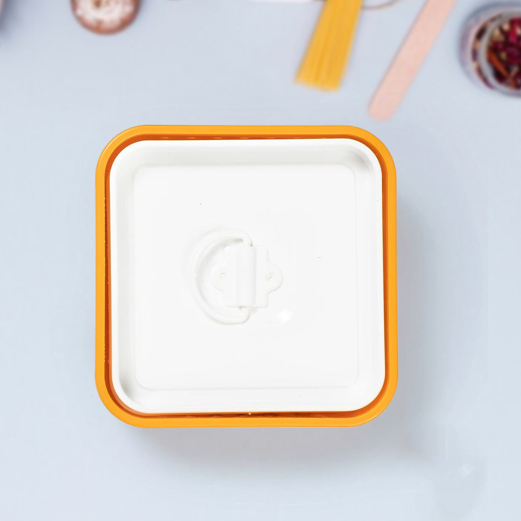 Square white plate with orange rim on a light gray background