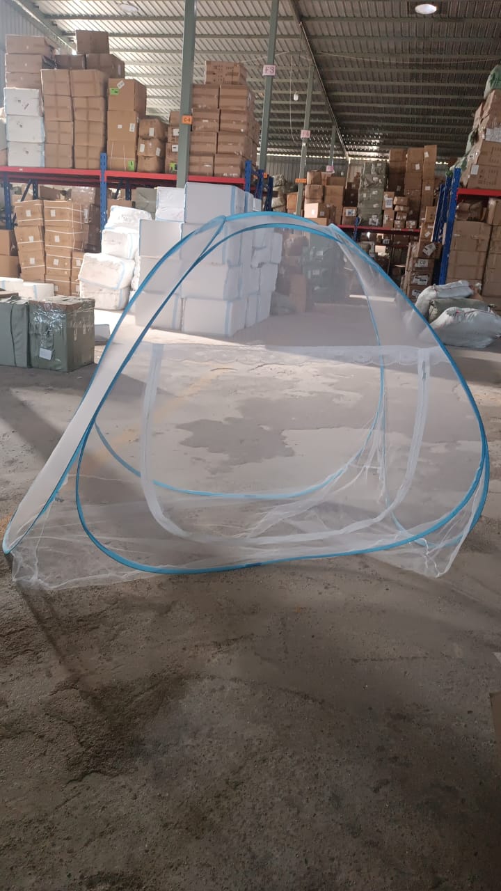 Pop-up tent with blue frame and white mesh in a warehouse setting